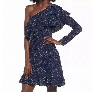 One shoulder, polka dot mini dress with lots of ruffles.